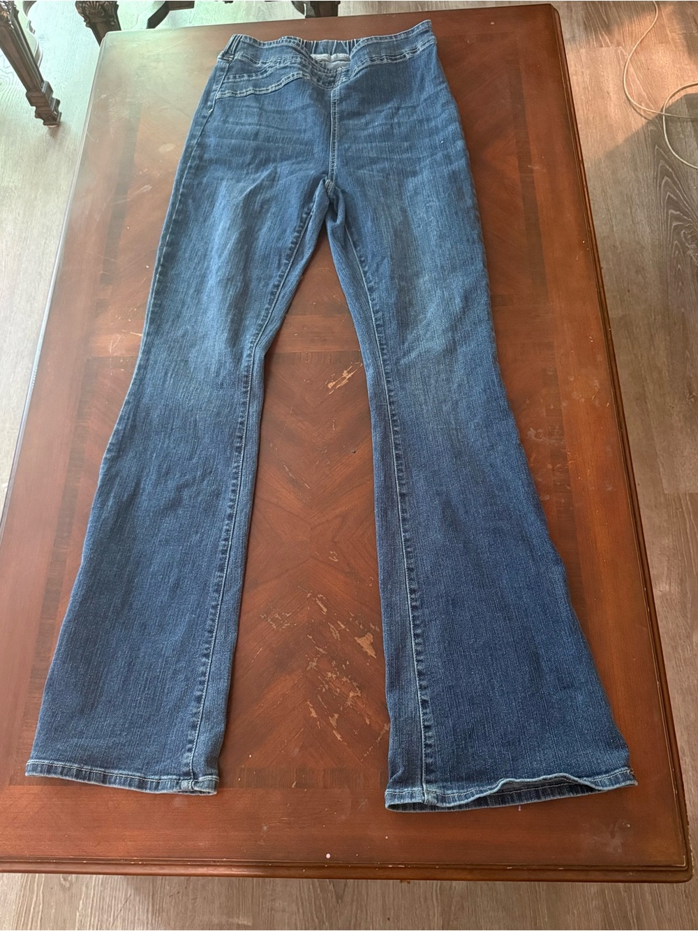 Pull on high rise flared jeans with stretch waists in the back
